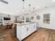 Open concept kitchen featuring an island with seating, granite countertops, and access to the living area at 325 Azalea Gaze Dr, Youngsville, NC 27596