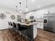 Kitchen features stainless appliances, granite countertops, a breakfast bar with seating, and natural light at 325 Azalea Gaze Dr, Youngsville, NC 27596