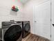 Well-lit laundry room equipped with modern Samsung washer and dryer and a wire shelf at 325 Azalea Gaze Dr, Youngsville, NC 27596