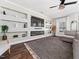 Comfortable living room boasting a modern fireplace, built-in shelving, and natural light at 325 Azalea Gaze Dr, Youngsville, NC 27596