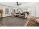 Inviting living room featuring a sectional sofa, stylish rug, ceiling fan, and open access to the kitchen at 325 Azalea Gaze Dr, Youngsville, NC 27596