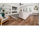 Bright living room showcasing a large gray sofa, sleek fireplace, and custom built-in shelving at 325 Azalea Gaze Dr, Youngsville, NC 27596