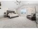 Spacious main bedroom featuring a vaulted ceiling, plush carpeting, and a seating area at 325 Azalea Gaze Dr, Youngsville, NC 27596