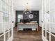 Home office with modern lighting, built-in shelves, and French doors at 325 Azalea Gaze Dr, Youngsville, NC 27596
