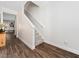 Bright foyer showcasing a carpeted staircase with white railing and wood-look floors at 325 Azalea Gaze Dr, Youngsville, NC 27596