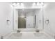 Bathroom featuring double vanity, ample lighting, and a large mirror creating a spacious and functional area at 3306 Leaflet Church Rd, Broadway, NC 27505