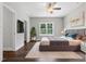Comfortable bedroom with a large window, ceiling fan, and plush bedding at 3306 Leaflet Church Rd, Broadway, NC 27505