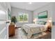 Bright bedroom with a large window, hardwood floors, and stylish decor at 3306 Leaflet Church Rd, Broadway, NC 27505