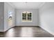 Bright dining room featuring hardwood floors, modern chandelier, and natural light from the large window at 3306 Leaflet Church Rd, Broadway, NC 27505