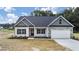 Charming single-Gathering home with stone accents and a two-car garage on a sunny day at 3306 Leaflet Church Rd, Broadway, NC 27505