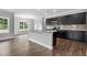 Open concept kitchen with a large island, granite counters, and dark cabinets at 3306 Leaflet Church Rd, Broadway, NC 27505