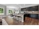 Modern kitchen featuring dark cabinets, stainless steel appliances, and a center island with seating at 3306 Leaflet Church Rd, Broadway, NC 27505