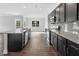Kitchen with granite counters, dark cabinets and stainless steel appliances open to the living area at 3306 Leaflet Church Rd, Broadway, NC 27505