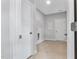 Clean laundry room with white doors, tile flooring, and ample space for laundry appliances and organization at 3306 Leaflet Church Rd, Broadway, NC 27505