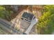 Birds eye view of a home featuring a long driveway, well-maintained lawn, and surrounded by lush trees at 3328 Leaflet Church Rd, Broadway, NC 27505