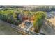 Scenic aerial view showcasing a home with a driveway, surrounded by a dense forest and open land at 3328 Leaflet Church Rd, Broadway, NC 27505