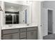 Bathroom features double sinks, quartz countertops, and a glass enclosed shower with dark tiling at 3328 Leaflet Church Rd, Broadway, NC 27505