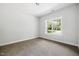 Carpeted bedroom features a view of the backyard at 3328 Leaflet Church Rd, Broadway, NC 27505