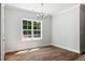 Bright dining room features hardwood floors and a view of the backyard through a large window at 3328 Leaflet Church Rd, Broadway, NC 27505