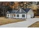 Charming home with a manicured lawn, elegant architectural details, and a spacious driveway at 3328 Leaflet Church Rd, Broadway, NC 27505