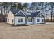 Attractive home with dark trim, multiple windows, established landscaping, and a long concrete driveway at 3328 Leaflet Church Rd, Broadway, NC 27505