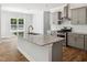 Modern kitchen with granite counters, stainless steel appliances, gray cabinets and hardwood floors at 3328 Leaflet Church Rd, Broadway, NC 27505