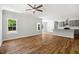 Expansive living room featuring hardwood floors, a ceiling fan and a view to the kitchen at 3328 Leaflet Church Rd, Broadway, NC 27505