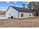 The back of a home featuring an attached garage, rear patio, several windows, and a lawn at 3328 Leaflet Church Rd, Broadway, NC 27505