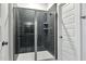 Modern bathroom shower with a glass enclosure and dark tiling at 3328 Leaflet Church Rd, Broadway, NC 27505