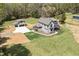 Aerial view of home showing the light gray exterior, black trim, green lawn, and matching detached garage at 3601 Bivins Rd, Hillsborough, NC 27278
