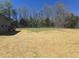 Expansive backyard featuring ample space and mature trees, providing a serene and private outdoor setting at 3601 Bivins Rd, Hillsborough, NC 27278
