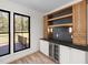 Stylish bar area includes a wine fridge, custom cabinetry, and elegant lighting for entertaining at 3601 Bivins Rd, Hillsborough, NC 27278