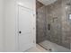 Elegant shower featuring sleek gray tiling, a glass enclosure, and modern fixtures, offering a spa-like experience at 3601 Bivins Rd, Hillsborough, NC 27278