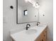 Modern bathroom showcasing double sinks, a quartz countertop, sleek black faucets and fixtures, and a large mirror at 3601 Bivins Rd, Hillsborough, NC 27278