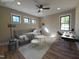 Bright bedroom features three windows, a modern ceiling fan, and stylish, comfortable furniture at 3601 Bivins Rd, Hillsborough, NC 27278