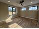 Bright bedroom featuring natural light, modern ceiling fan and sleek dark trim windows at 3601 Bivins Rd, Hillsborough, NC 27278