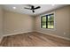 Cozy bedroom featuring hardwood floors, recessed lighting, and a large window at 3601 Bivins Rd, Hillsborough, NC 27278