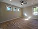 Bright bedroom features natural light, hardwood floors, and a ceiling fan at 3601 Bivins Rd, Hillsborough, NC 27278