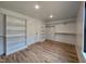 Spacious walk-in closet with custom shelving and wooden floors for optimal organization and style at 3601 Bivins Rd, Hillsborough, NC 27278