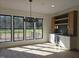 Bright dining area with large windows, bar with a wine cooler, and a view of a fenced yard at 3601 Bivins Rd, Hillsborough, NC 27278