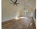 Open-concept great room with vaulted ceilings, hardwood floors and multiple windows at 3601 Bivins Rd, Hillsborough, NC 27278