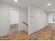 Bright hallway with hardwood floors, neutral walls, and white trim at 3601 Bivins Rd, Hillsborough, NC 27278