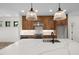 Gourmet kitchen boasts custom cabinetry, stone countertops, and designer lighting at 3601 Bivins Rd, Hillsborough, NC 27278