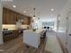 Virtually staged kitchen with center island, wood cabinets, stainless appliances, and view to dining room at 3601 Bivins Rd, Hillsborough, NC 27278