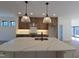 Stunning kitchen island featuring waterfall countertops and modern lighting fixtures at 3601 Bivins Rd, Hillsborough, NC 27278