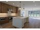 Modern kitchen with stainless steel appliances, custom cabinets, and a large center island at 3601 Bivins Rd, Hillsborough, NC 27278