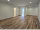 Open living area features hardwood flooring, white walls and recessed lighting at 3601 Bivins Rd, Hillsborough, NC 27278