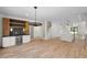 Open concept living space with hardwood floors, built-in bar, and ample natural light at 3601 Bivins Rd, Hillsborough, NC 27278