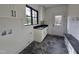 Bright mud room featuring a sink, tile floors, and a built-in bench at 3601 Bivins Rd, Hillsborough, NC 27278