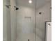 Modern shower with glass door, sleek fixtures, and tiled walls and floors at 3601 Bivins Rd, Hillsborough, NC 27278